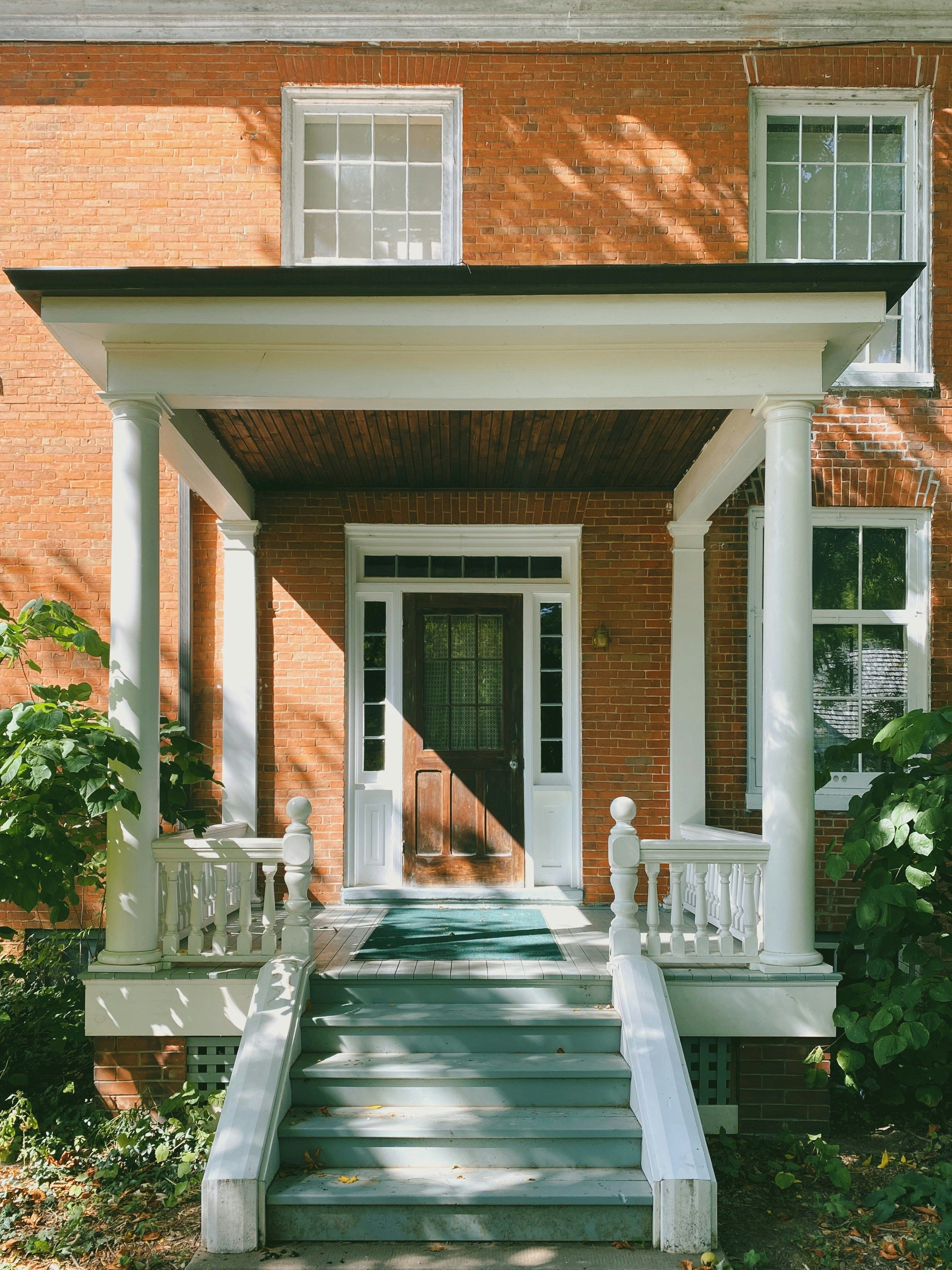 Custom portico addition at a home entry